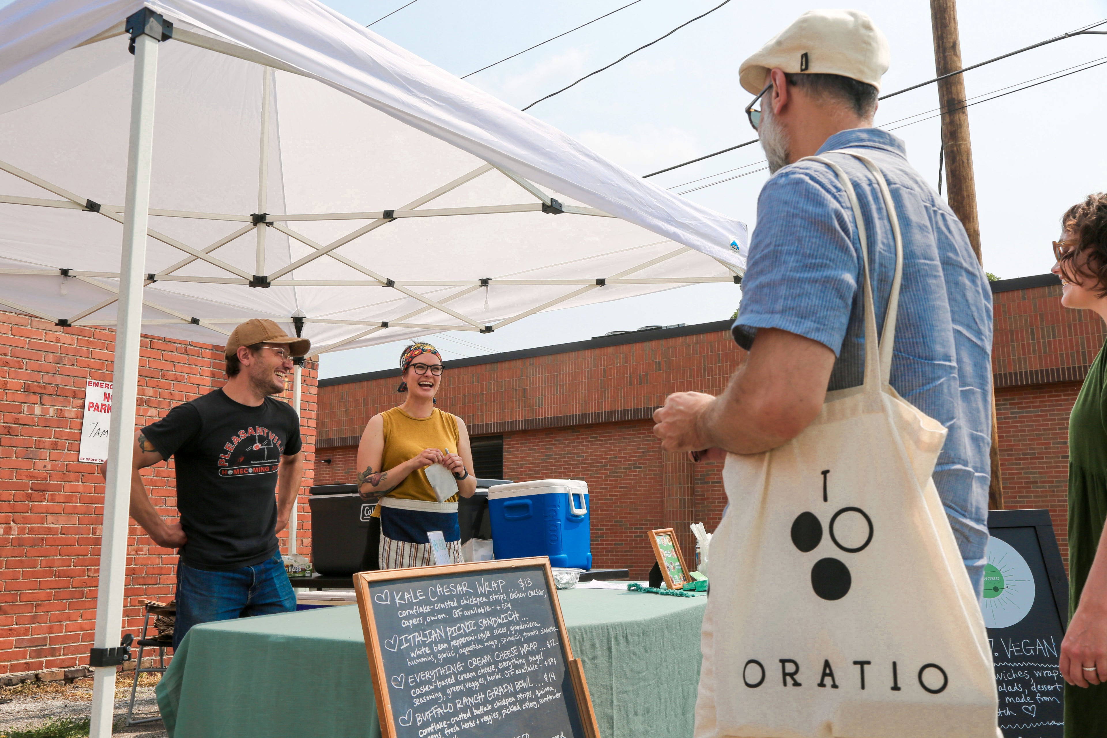 Chef Madeline Krantz at the New World Kitchen booth at the Northside Market in Des Moines, Iowa