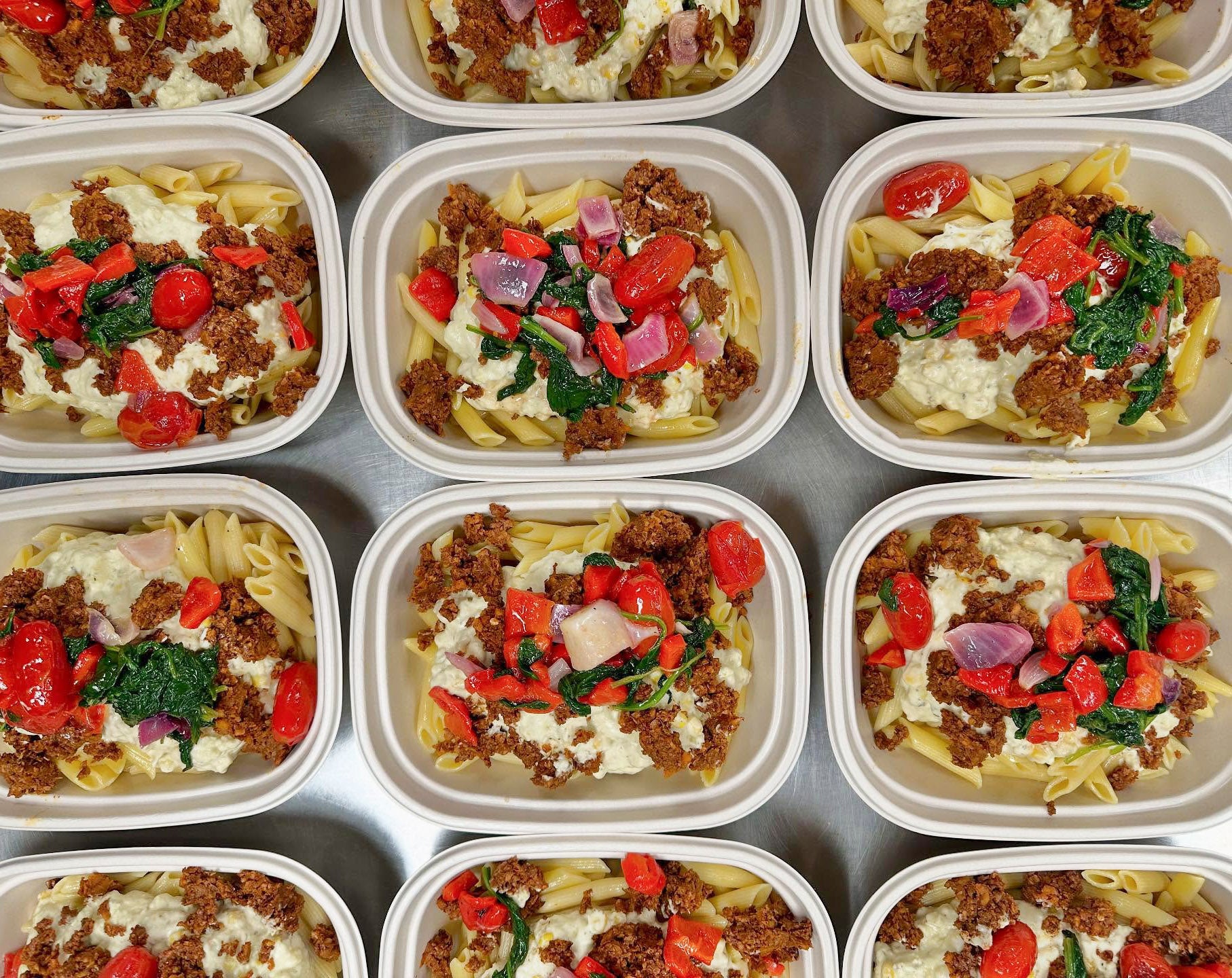 Vegan salads in compostable, plant fiber containers at New World Kitchen in Des Moines, Iowa